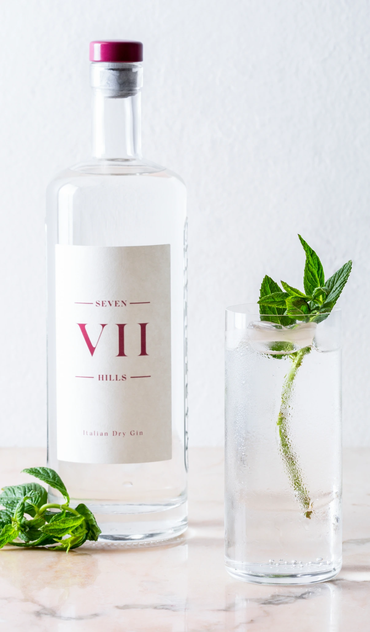 A VII Hills Gin bottle beside a gin and elderflower serve